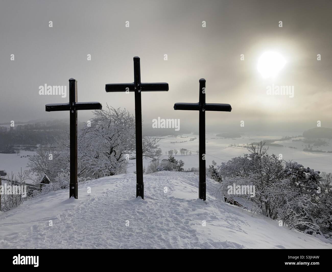 Summit crosses on a hill (Kornbühl) in scenic winter landscape with lots of snow in the Swabian Alps - Smartphone Captured Stock Image