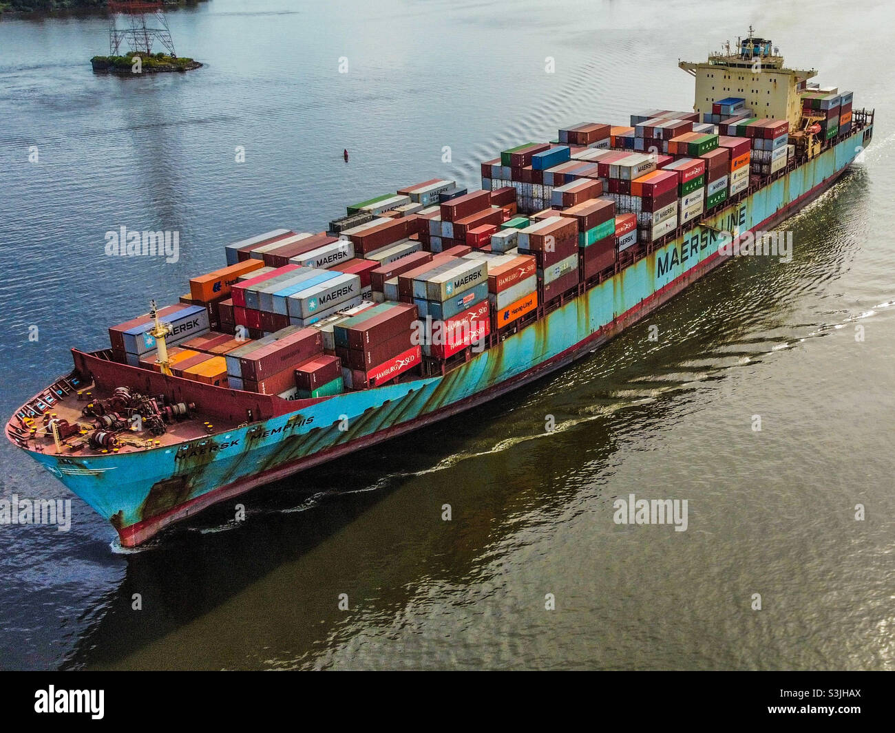 Container Cargo ship cruising up the Delaware River Stock Photo