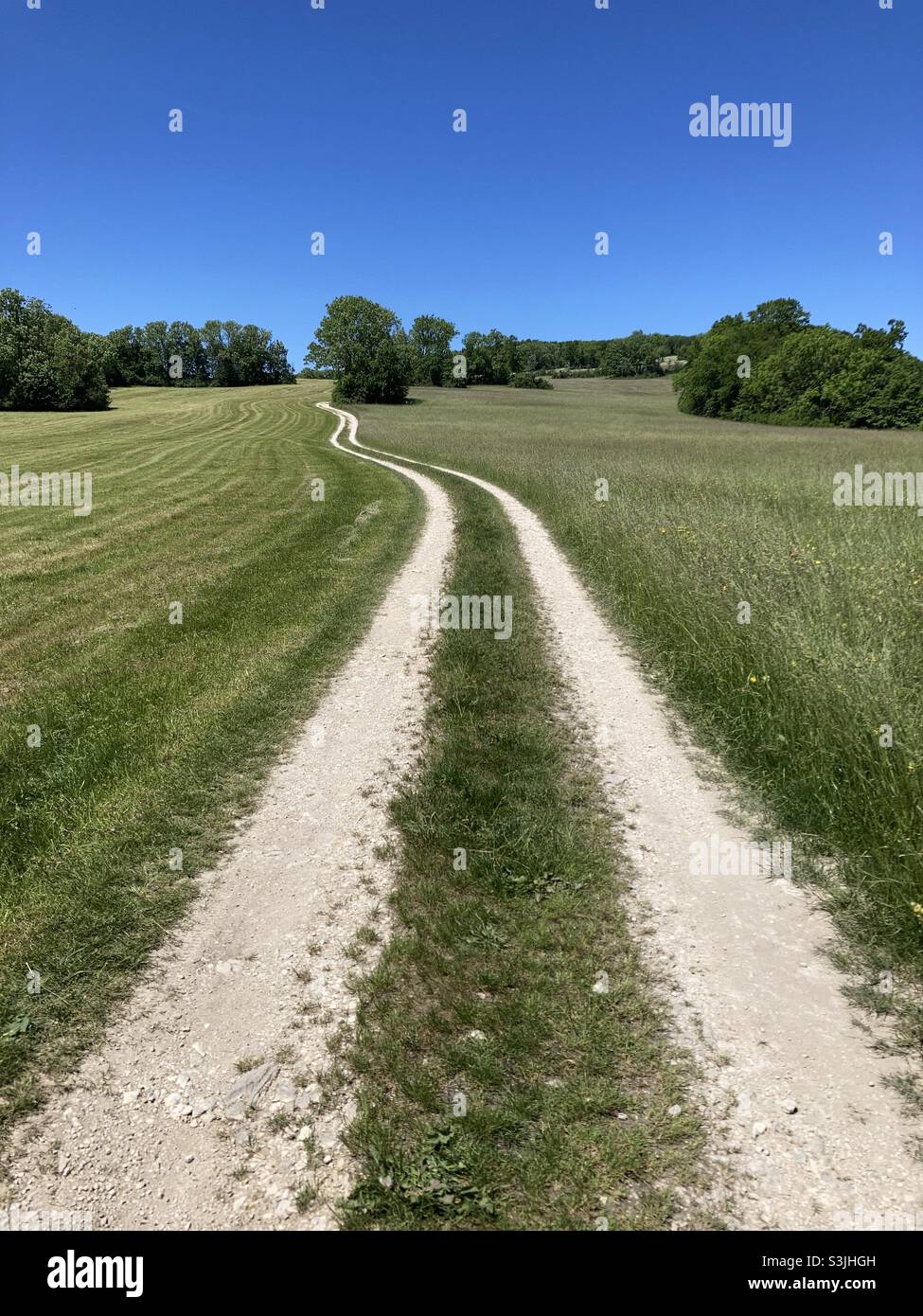Hiking trail through rural landscape in summer in the Swabian Alps in Southern Germany Stock Photo