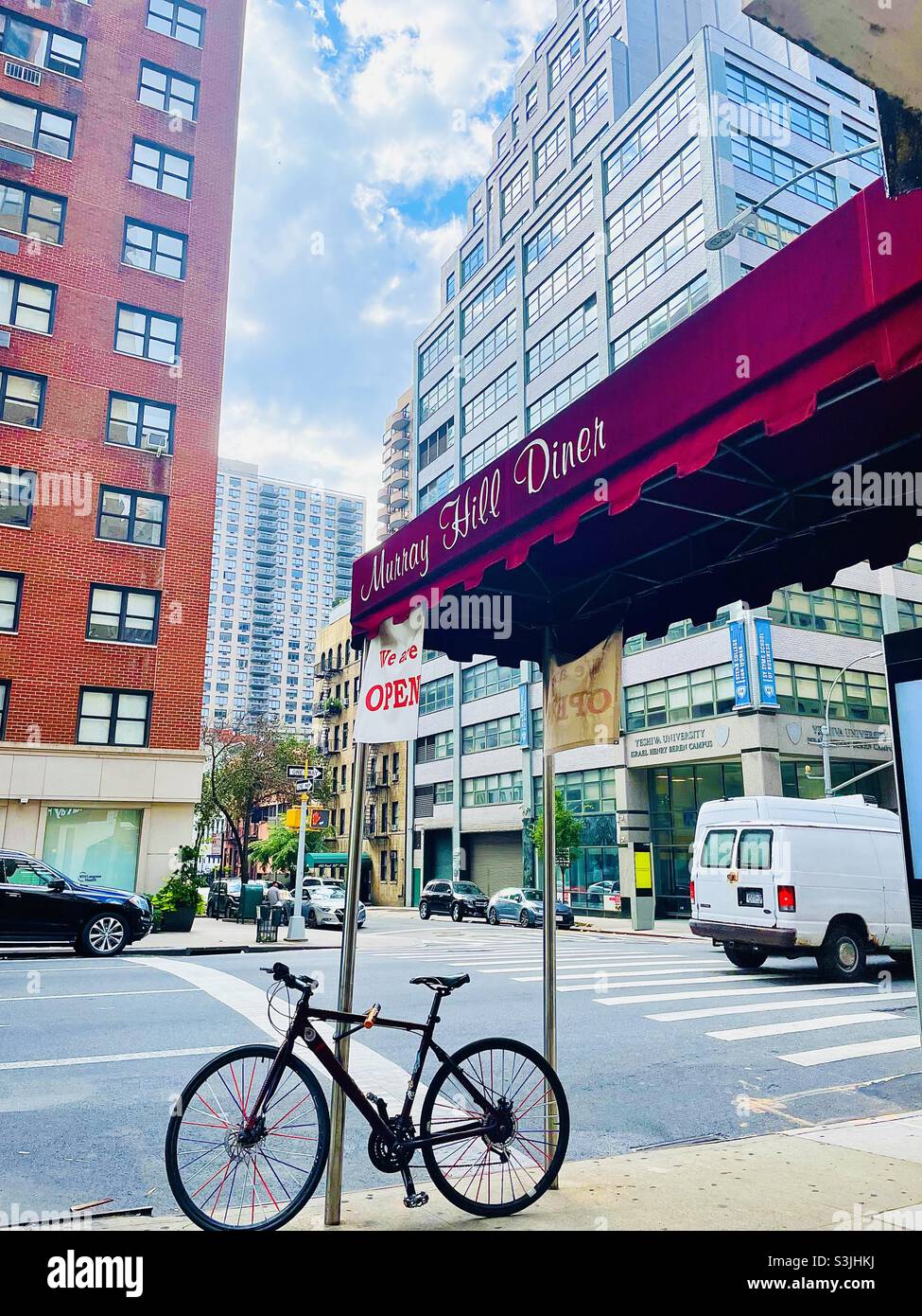 Bicycle under a red awning in New York City - Smartphone Captured Stock Image