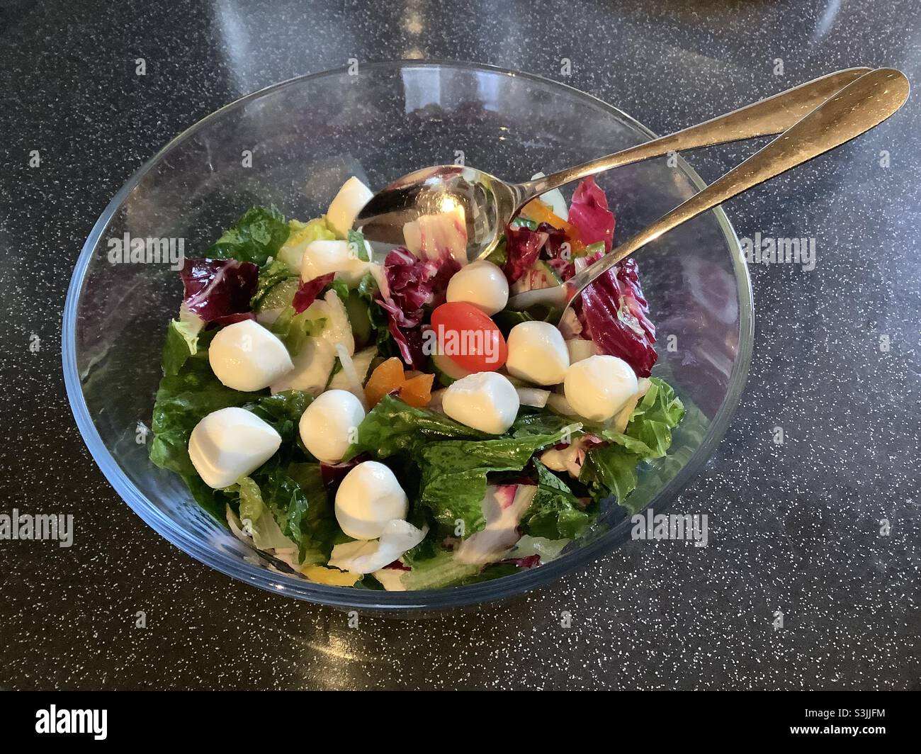 Mixed salad and Mozzarella cheese Balls in glass bowl Stock Photo