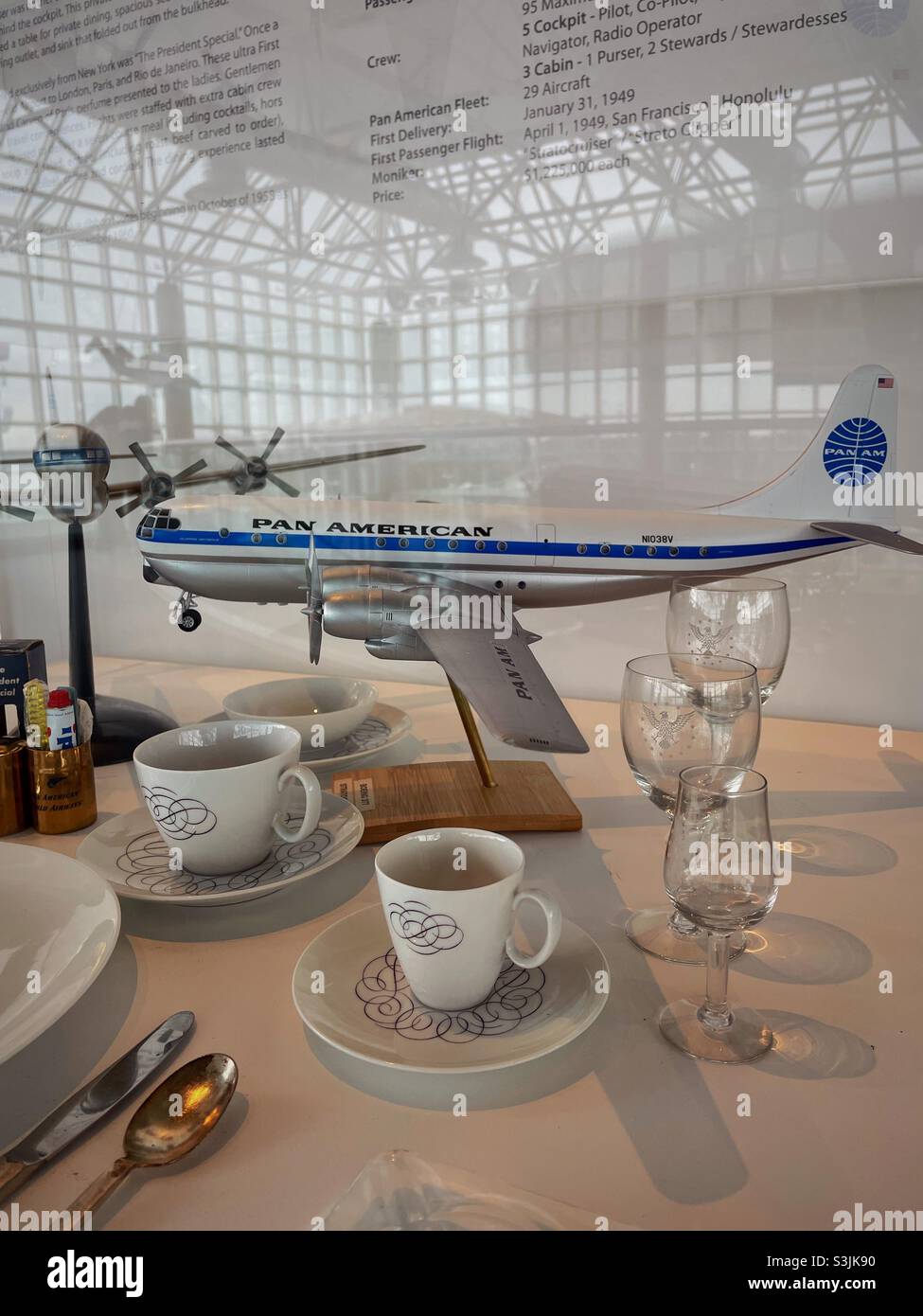 Display case of model airplane and dinner service from Pan American Airways at the Cradle of aviation Museum , Garden City Long Island, New York, 2021, USA - Smartphone Captured Stock Image