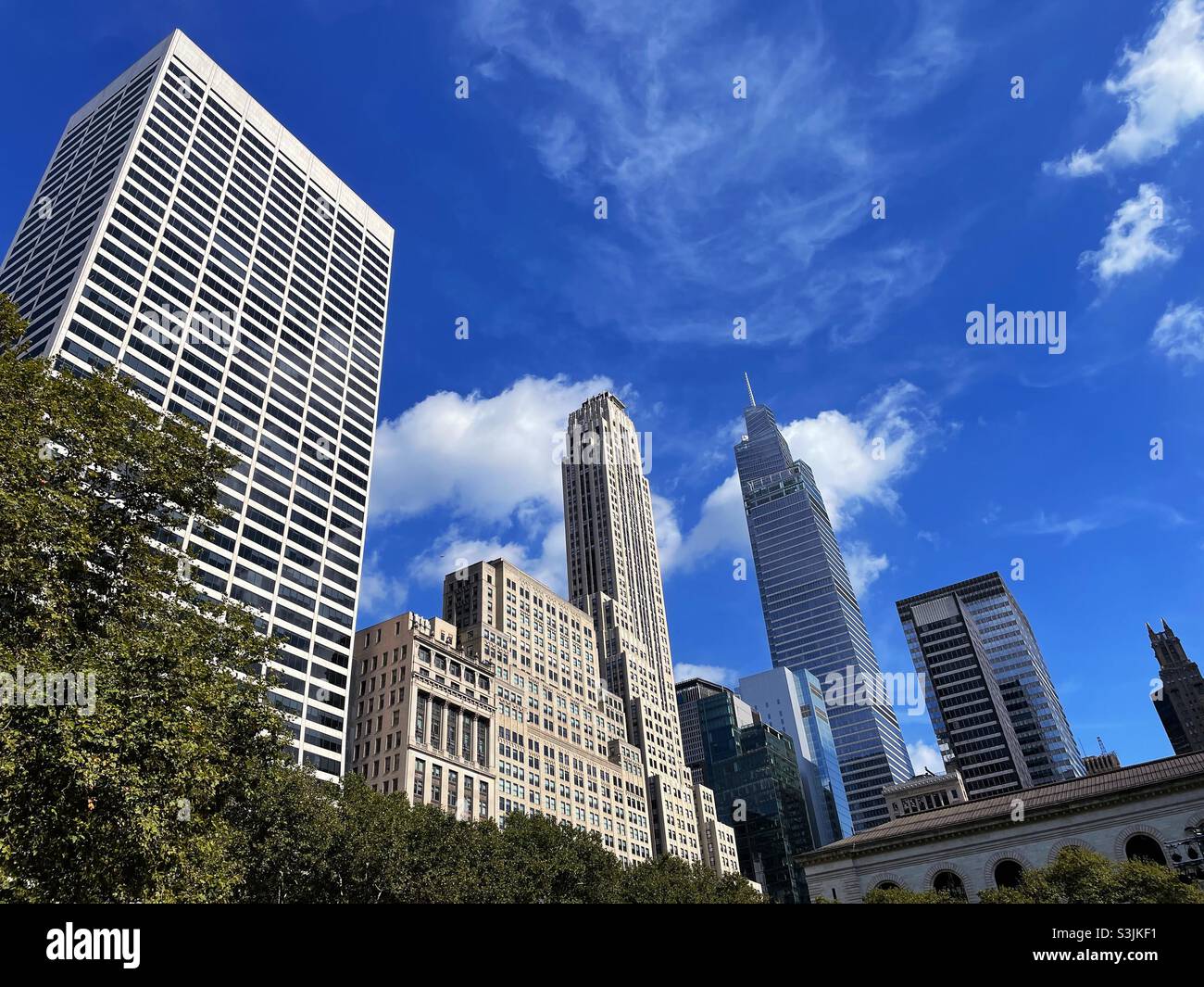 Skyscrapers and One Vanderbilt as seen from Bryant Park behind the main branch of the new York public library, NYC, USA, 2021 - Smartphone Captured Stock Image
