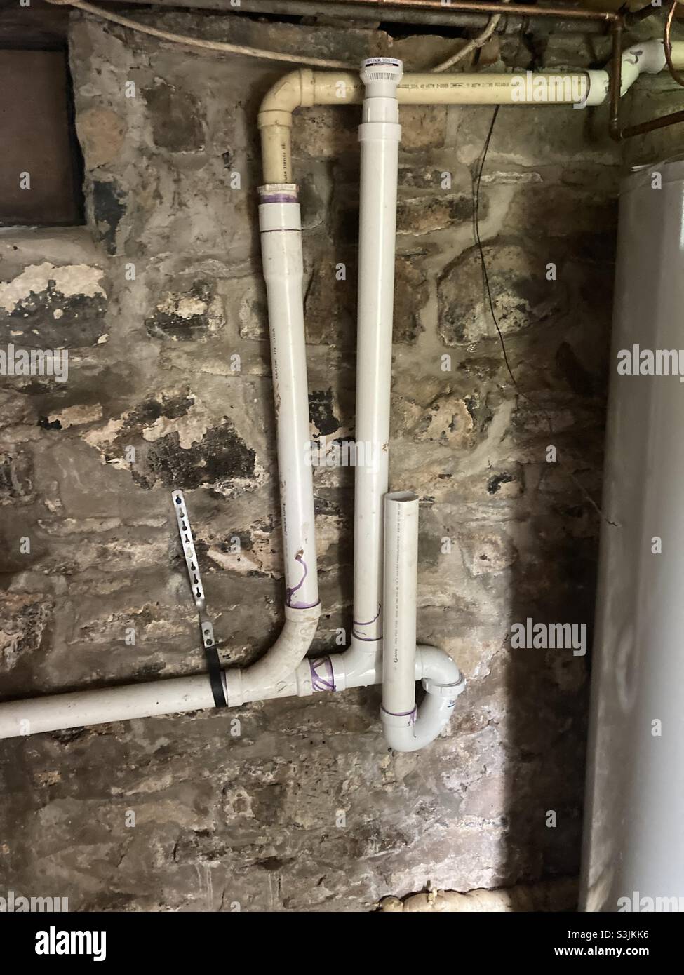 Drain Pipes Attached to an Old Stone Foundation Wall Stock Photo Alamy