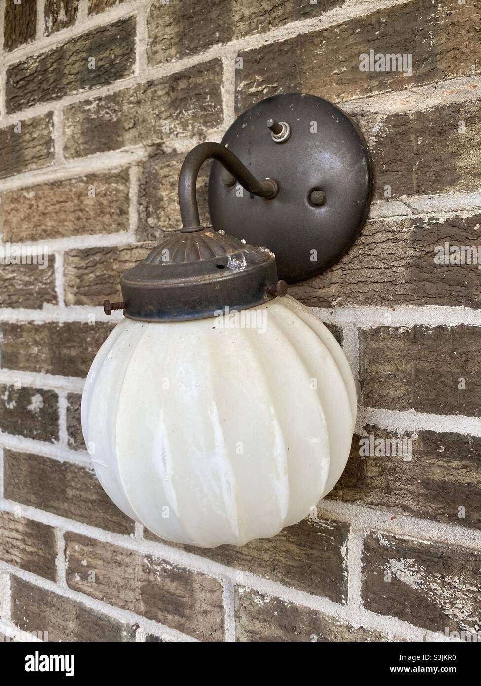 Electric lamp mounted on brick wall Stock Photo