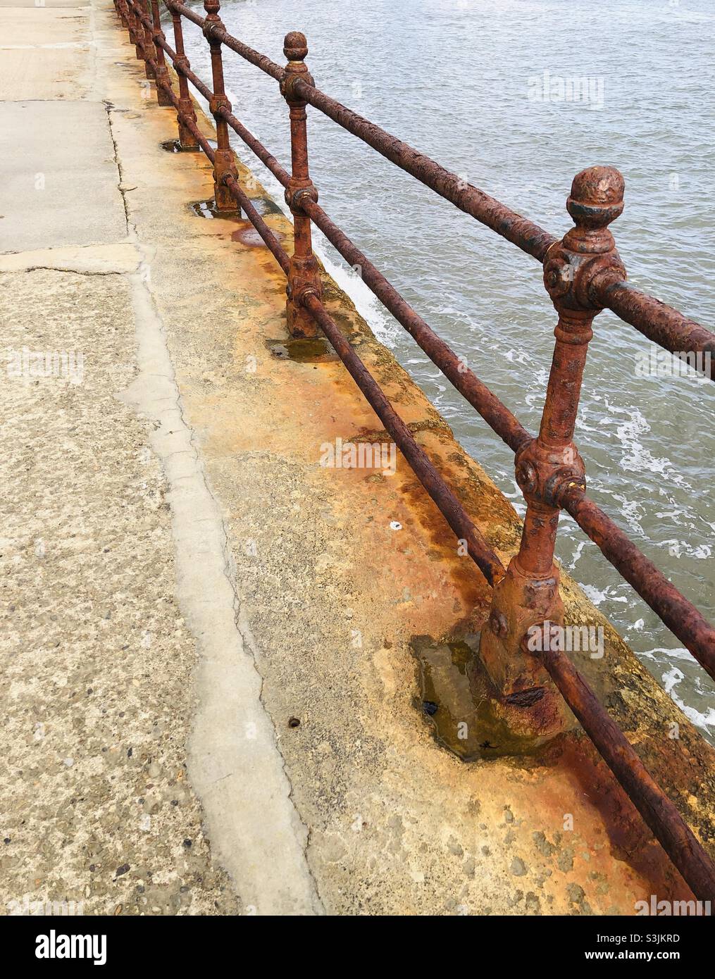 Rusting railings on a seaside promenade - Smartphone Captured Stock Image