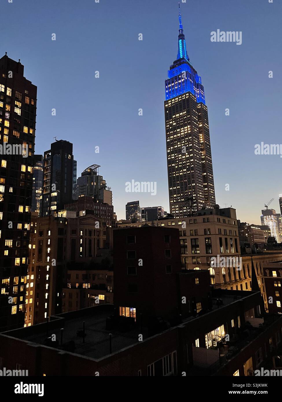 A view of the Empire State building and other skyscrapers in New York City silhouetted against the evening sky - Smartphone Captured Stock Image