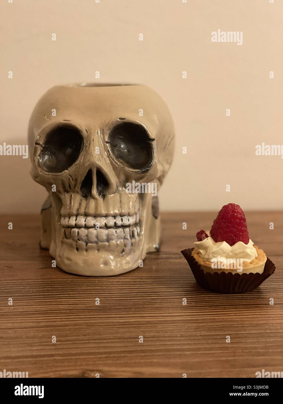 Trick or treat with an artistic skull and a beautiful pastry - Smartphone Captured Stock Image