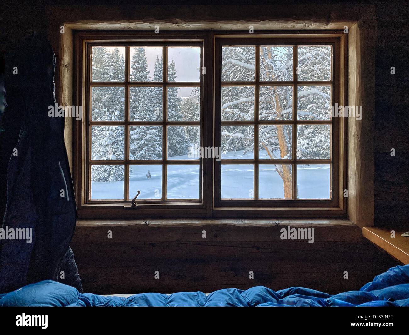 View from inside a mountain hut in Winter at sunrise, Vail, Colorado, USA - Smartphone Captured Stock Image