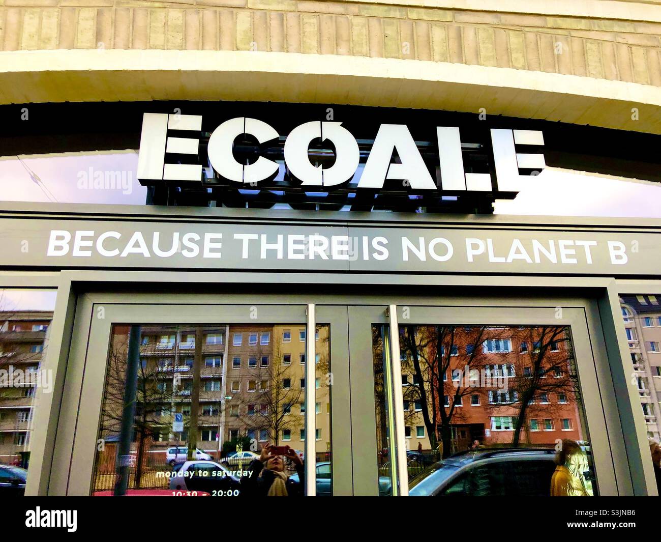 Berlin clothing storefront with street scene reflected in the windows. - Smartphone Captured Stock Image