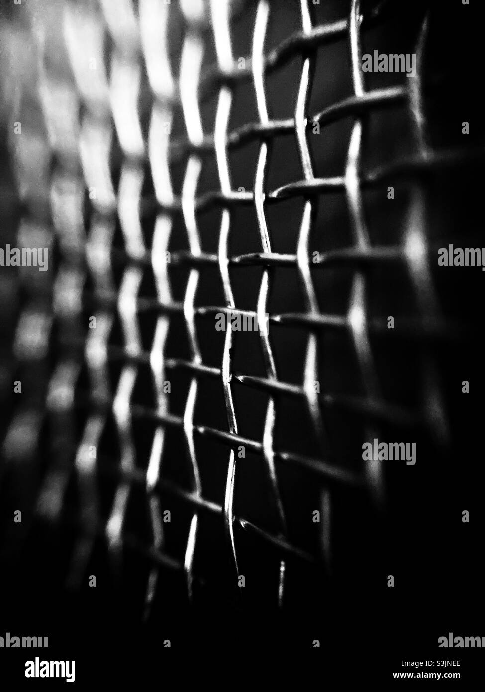 Iron fence as black and white silhouette under angle view Stock Photo