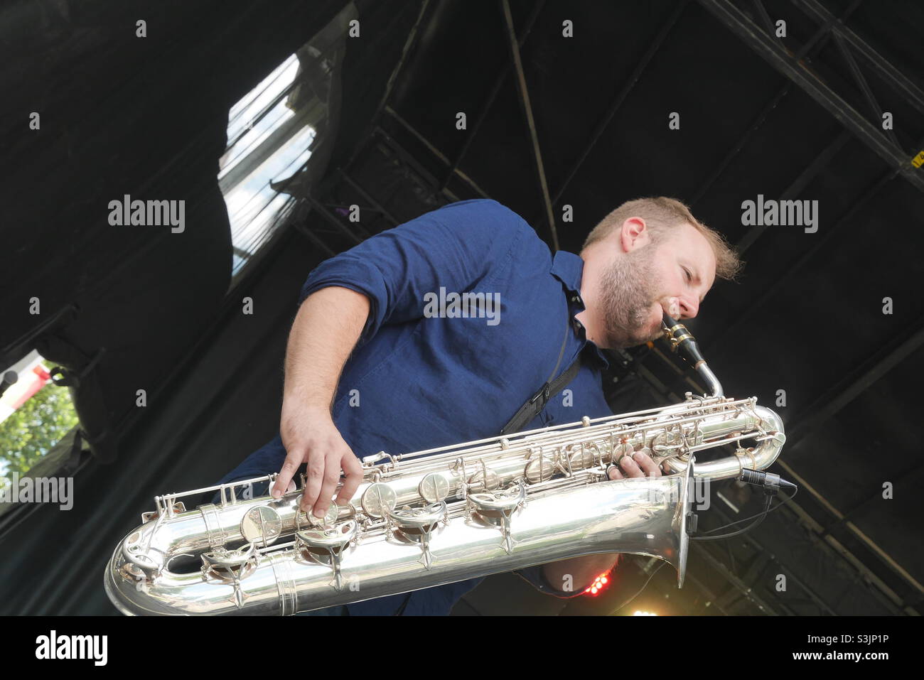 Belgian Musician at Canadian Sunfest playing huge saxophone bassoon type instrument Stock Photo