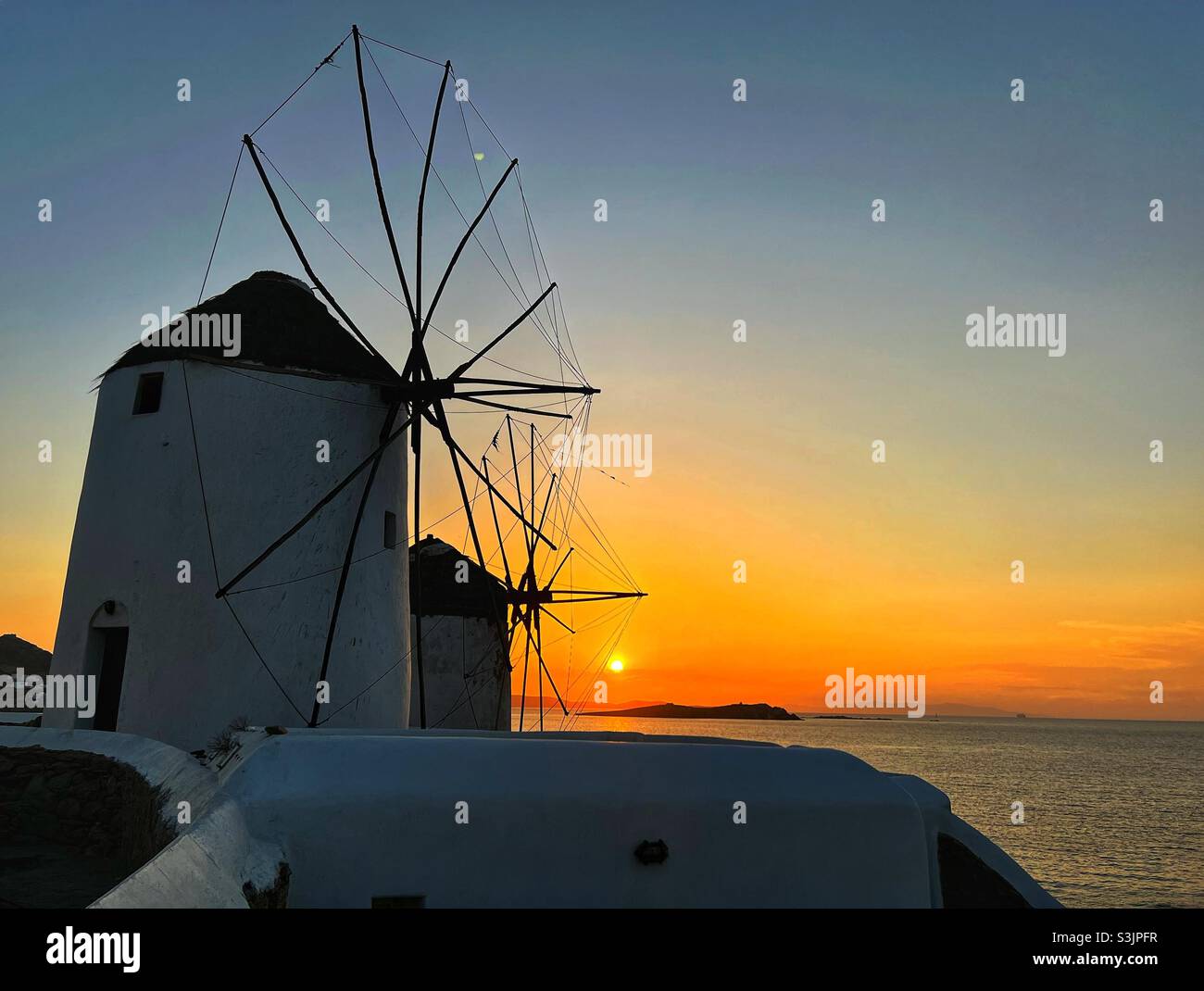 Mykonos, Greece,  Windmills with the sunset behind Stock Photo