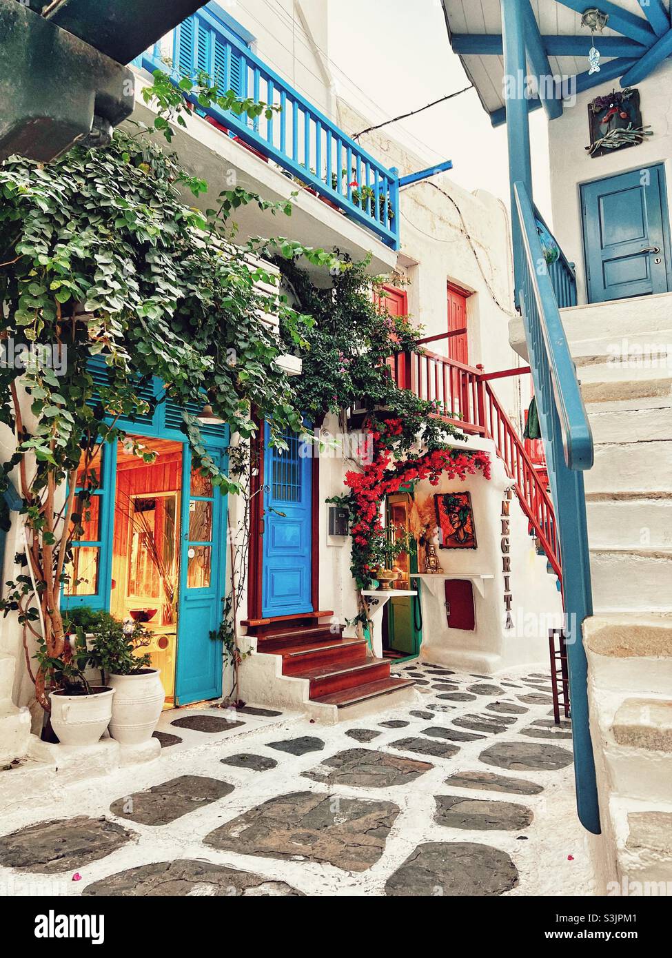 Street in Mykonos Town in Greece with steps and shops - Smartphone Captured Stock Image