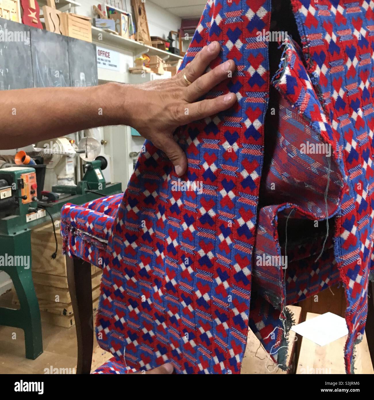 Reupholstering chair with London Underground vintage fabric during