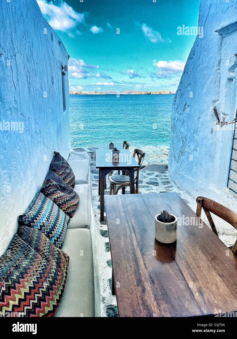 View of the Aegean Sea in Mykonos Greece from a side alley - Smartphone Captured Stock Image