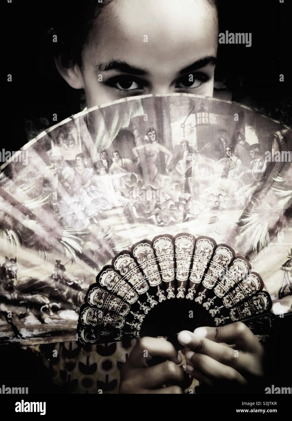 Mixed race girl with a fan. - Smartphone Captured Stock Image