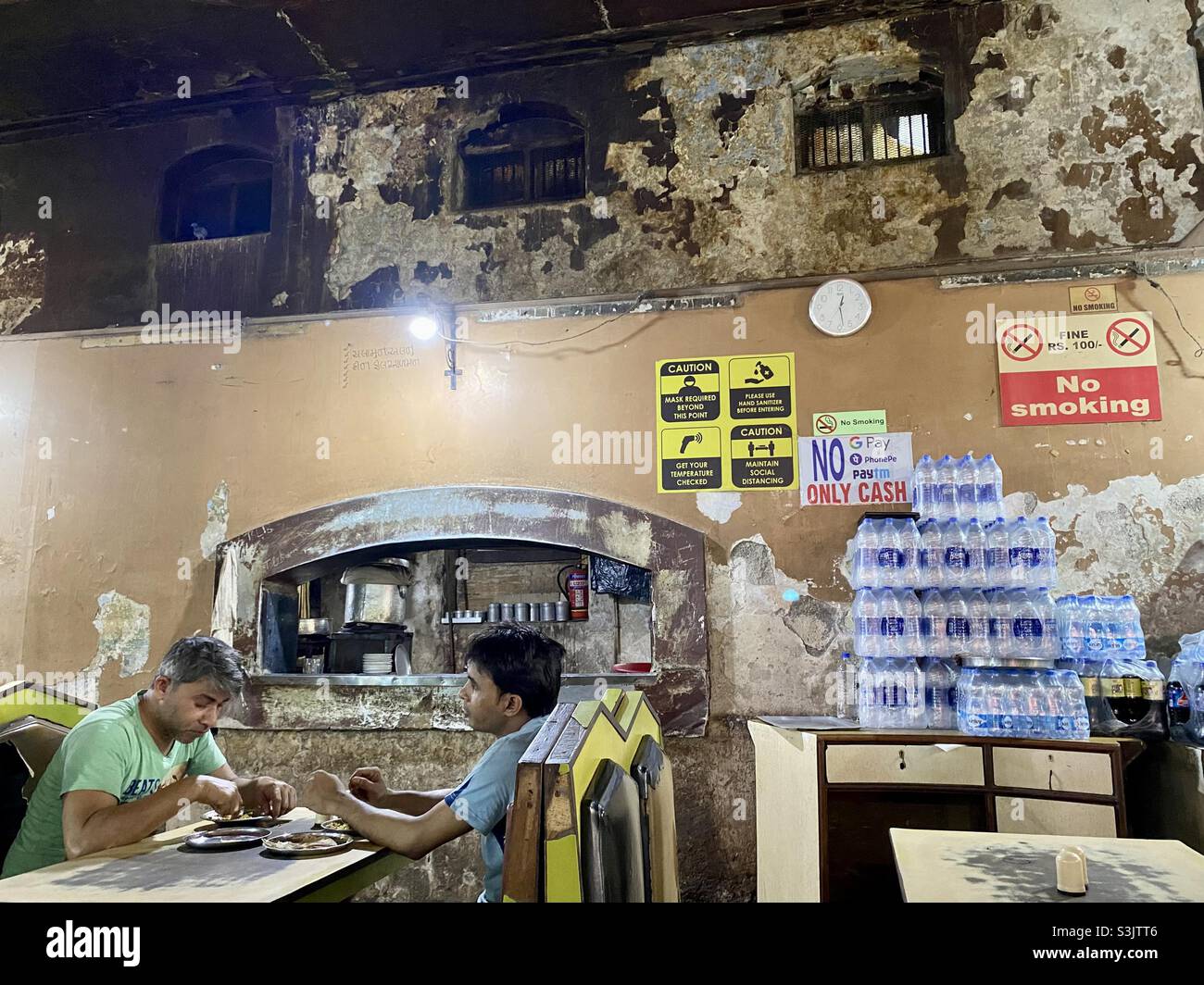 Local having lunch at very old restaurant in mumbai. Radio Restaurant in south mumbai is about 90 years old. - Smartphone Captured Stock Image