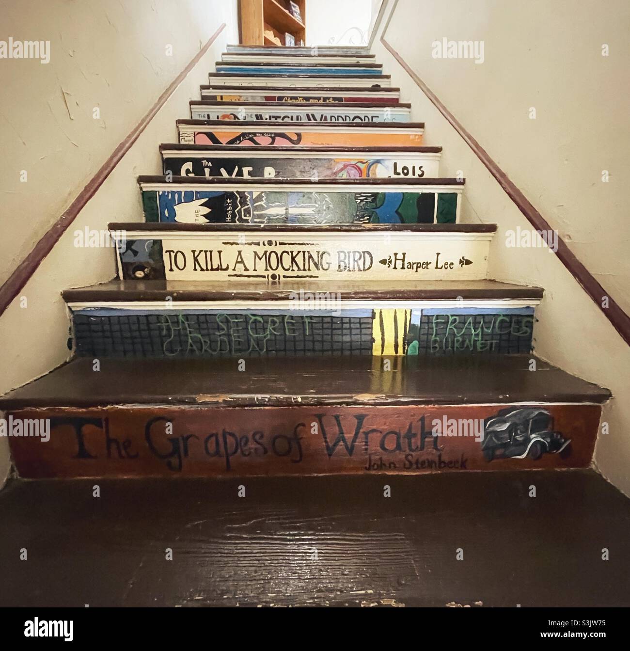 Bookstore staircase painted to resemble book spines Stock Photo Alamy