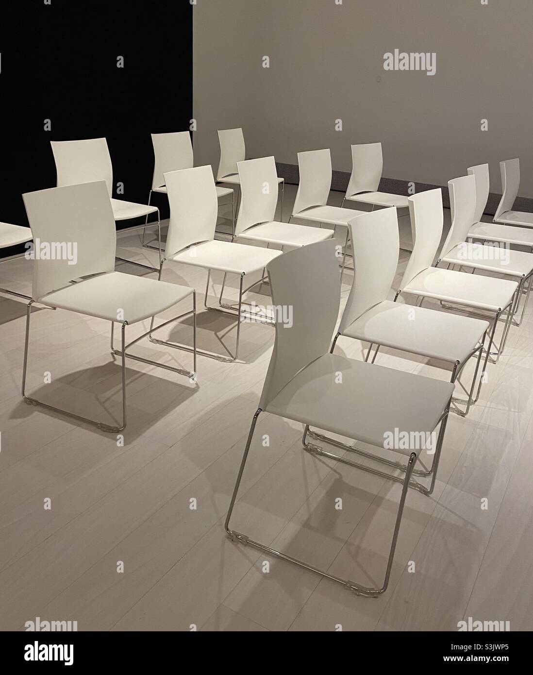 Empty class or lecture room awaiting an audience to arrive. Neatly arranged and with high quality furniture and neat presentation of the room. Stock Photo