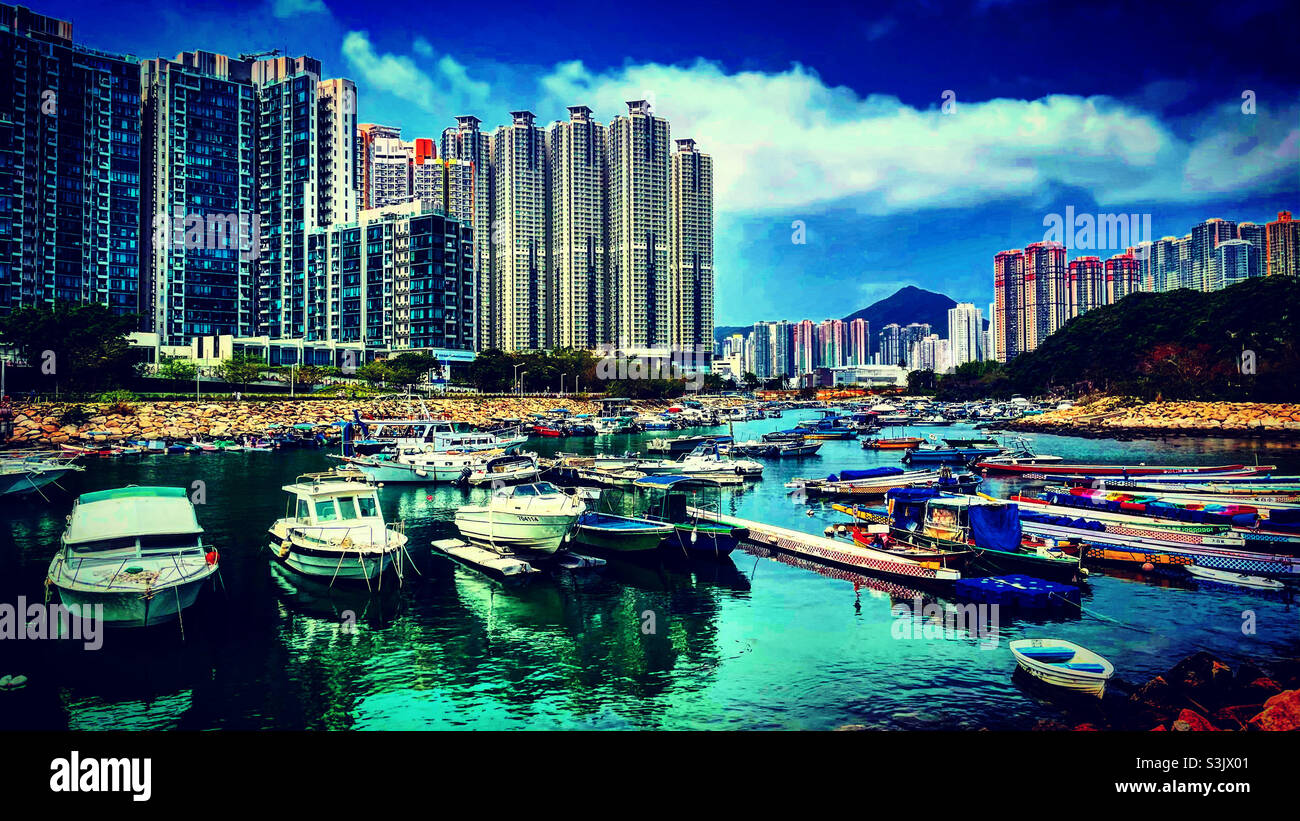hong kong harbor near TKO Tseung Kwan O with the sea or ocean and the boats with towers developments Stock Photo