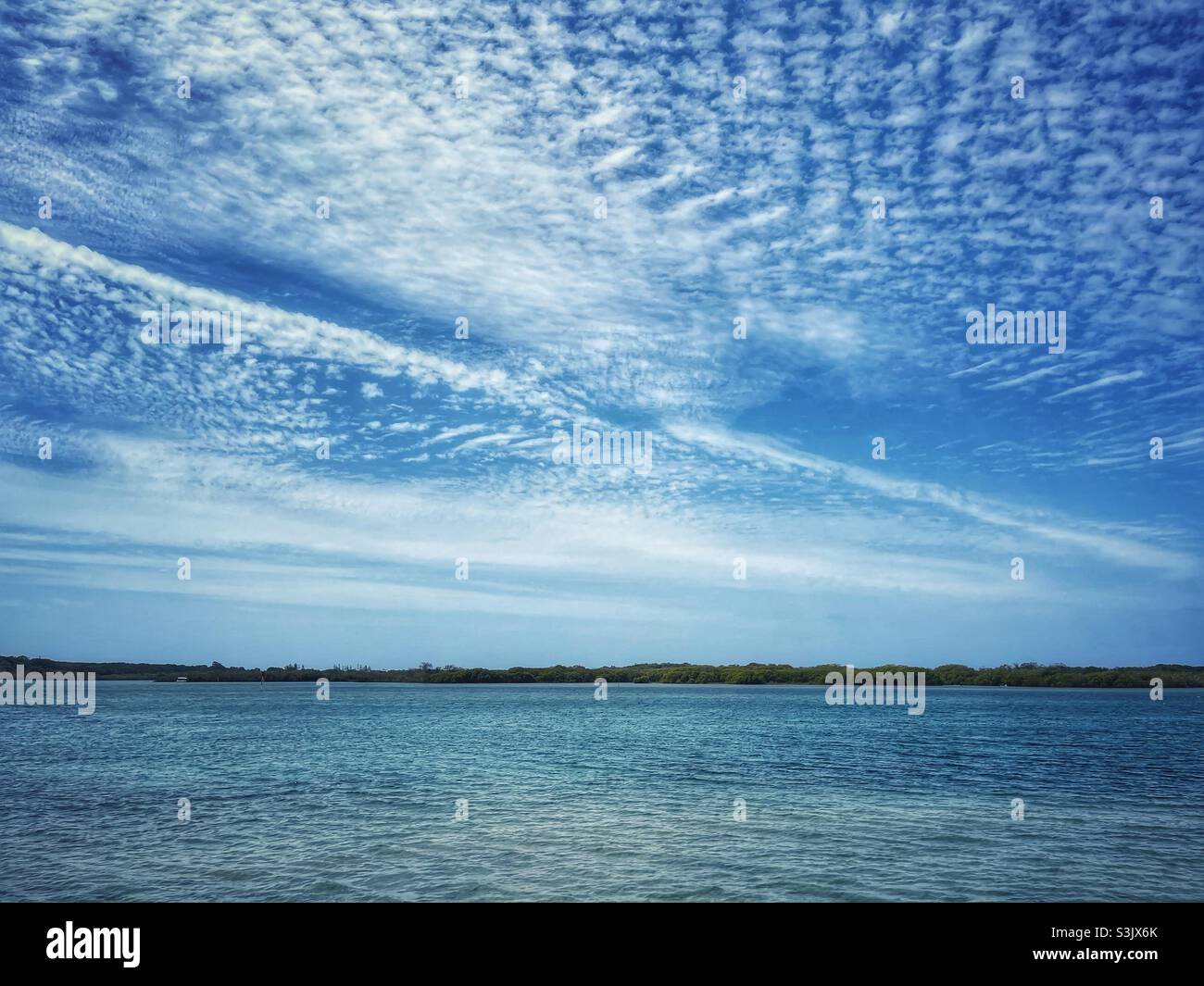 Spectacular cloudy sky over the ocean on the Sunshine Coast, northern of Brisbane, Queensland, Australia - Smartphone Captured Stock Image