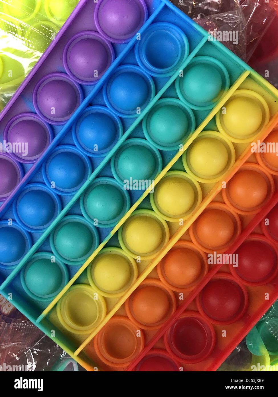 Rainbow colours on a plastic toy Stock Photo