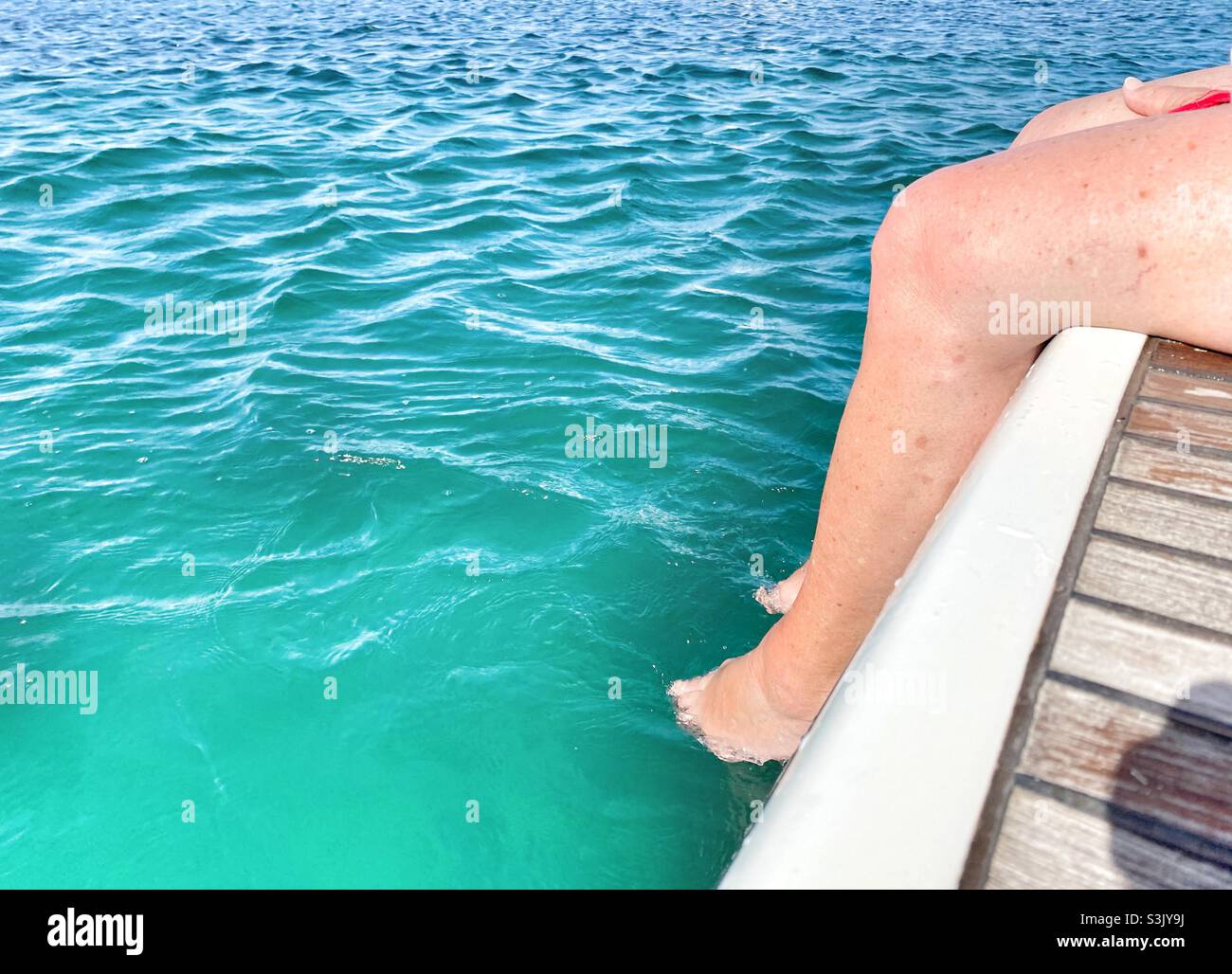 Relaxing With your feet in the sea Stock Photo