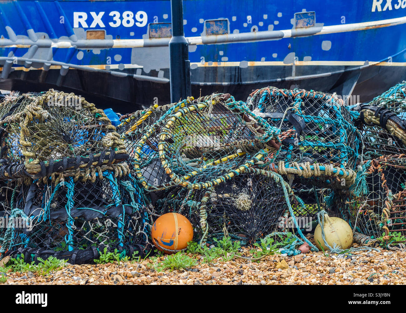 A tangle of lobster pots and ropes and buoys on a stony beach - Smartphone Captured Stock Image