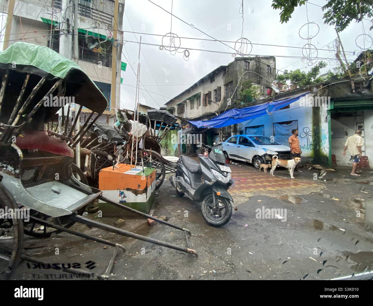 Kolkata city view with hand pulled rickshaw and two wheelers - Smartphone Captured Stock Image