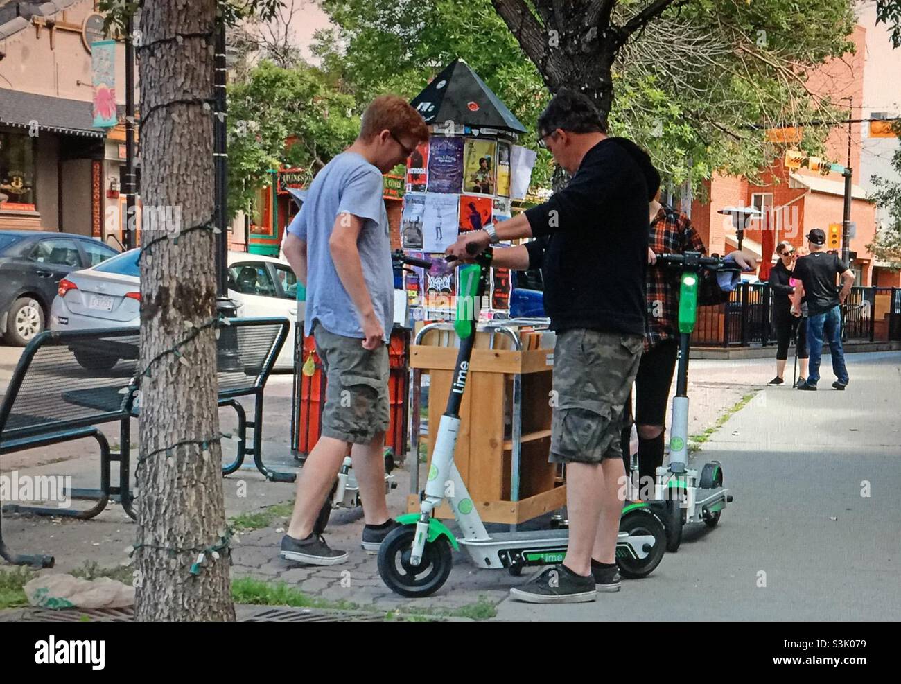 Kensington, Calgary, Alberta, street corner, scooter rental, book stand