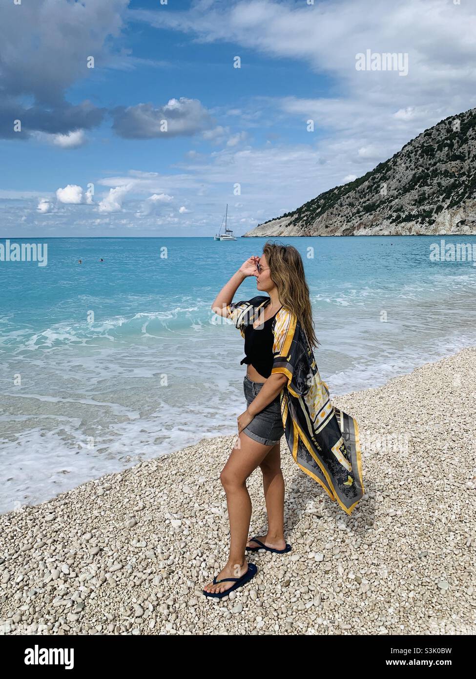 Woman looking out to sea at Myrtos beach kefalonia Stock Photo