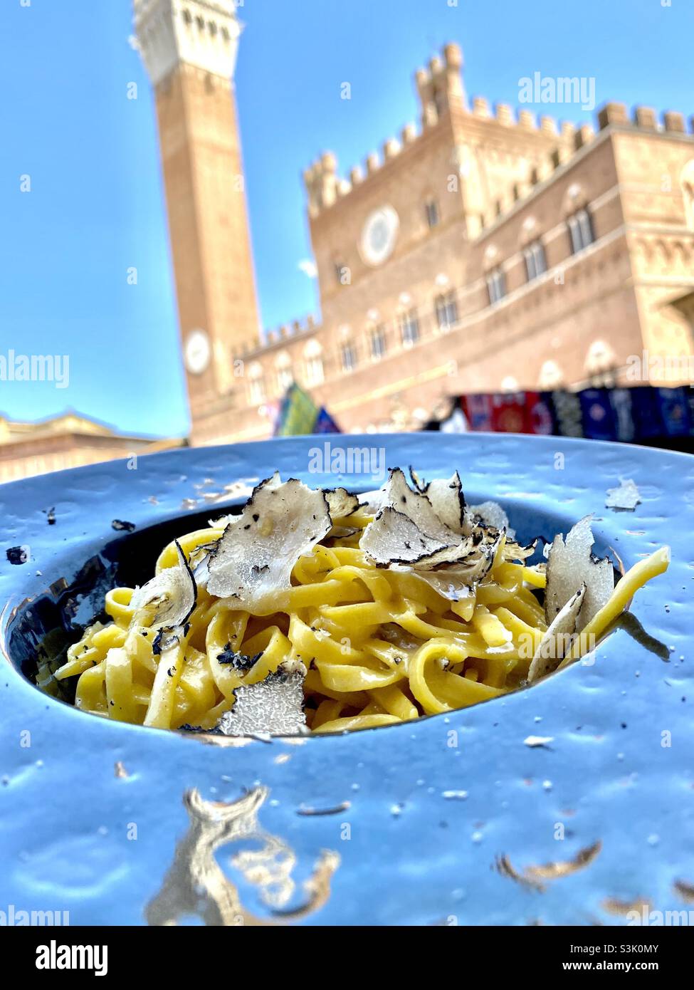 Outdoor dining of Truffle fettuccine in the iconic plaza of Sienna, Italy - Smartphone Captured Stock Image