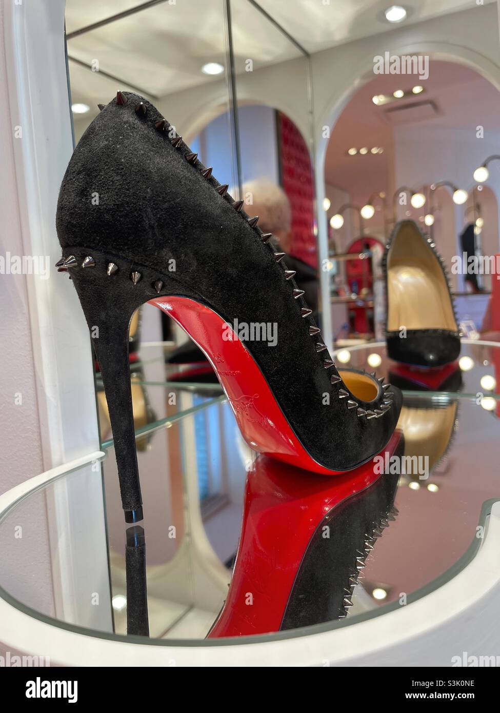 Christian Louboutin High heel shoe features it's signature red soles, Saks  fifth Ave., NYC, USA Stock Photo - Alamy