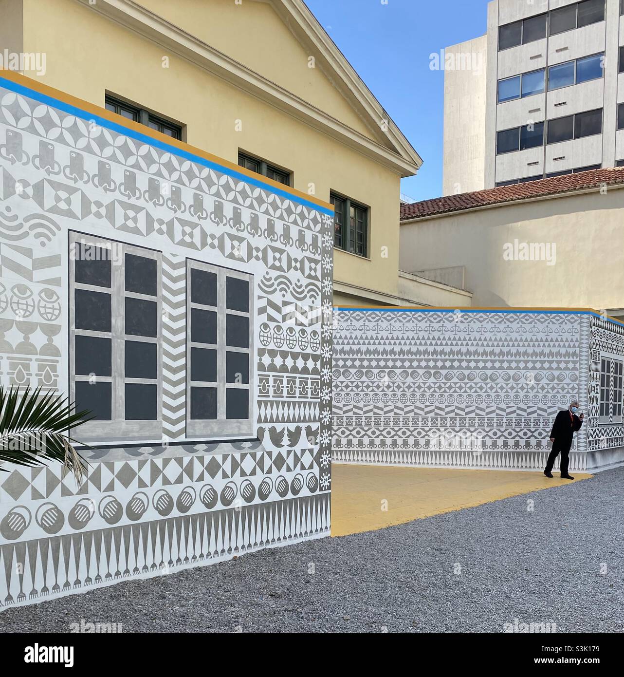 Mural by Navine Khan-Dossos on the former Santa Rosa Courthouse in Athens, Greece, as part of the 2021 Athens Biennale. The mural uses ‘xysta’, a style of black & white decoration from Chios Island. Stock Photo
