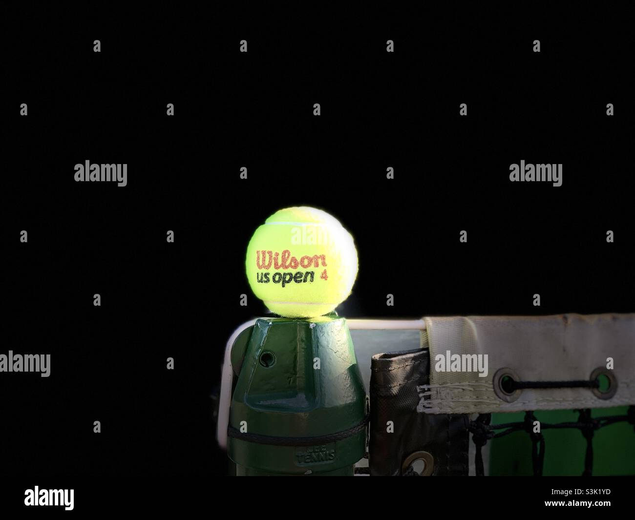 Tennis balls, Wilson us open 4 in the net with black background. - Smartphone Captured Stock Image