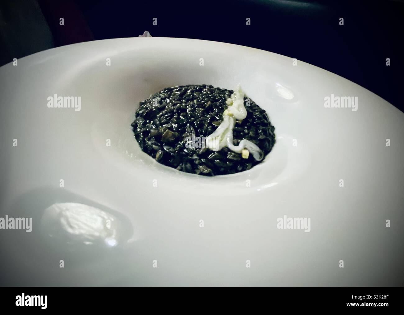 Squid ink risotto in Venice, Italy Stock Photo