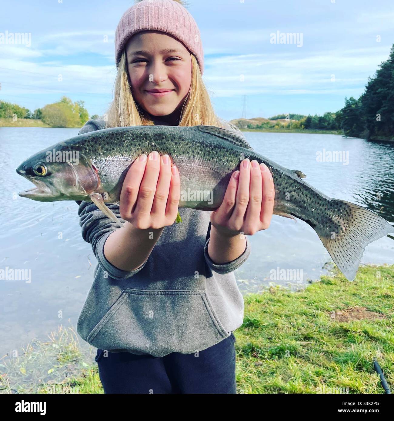 Happy girl caught a rainbow trout Stock Photo - Alamy