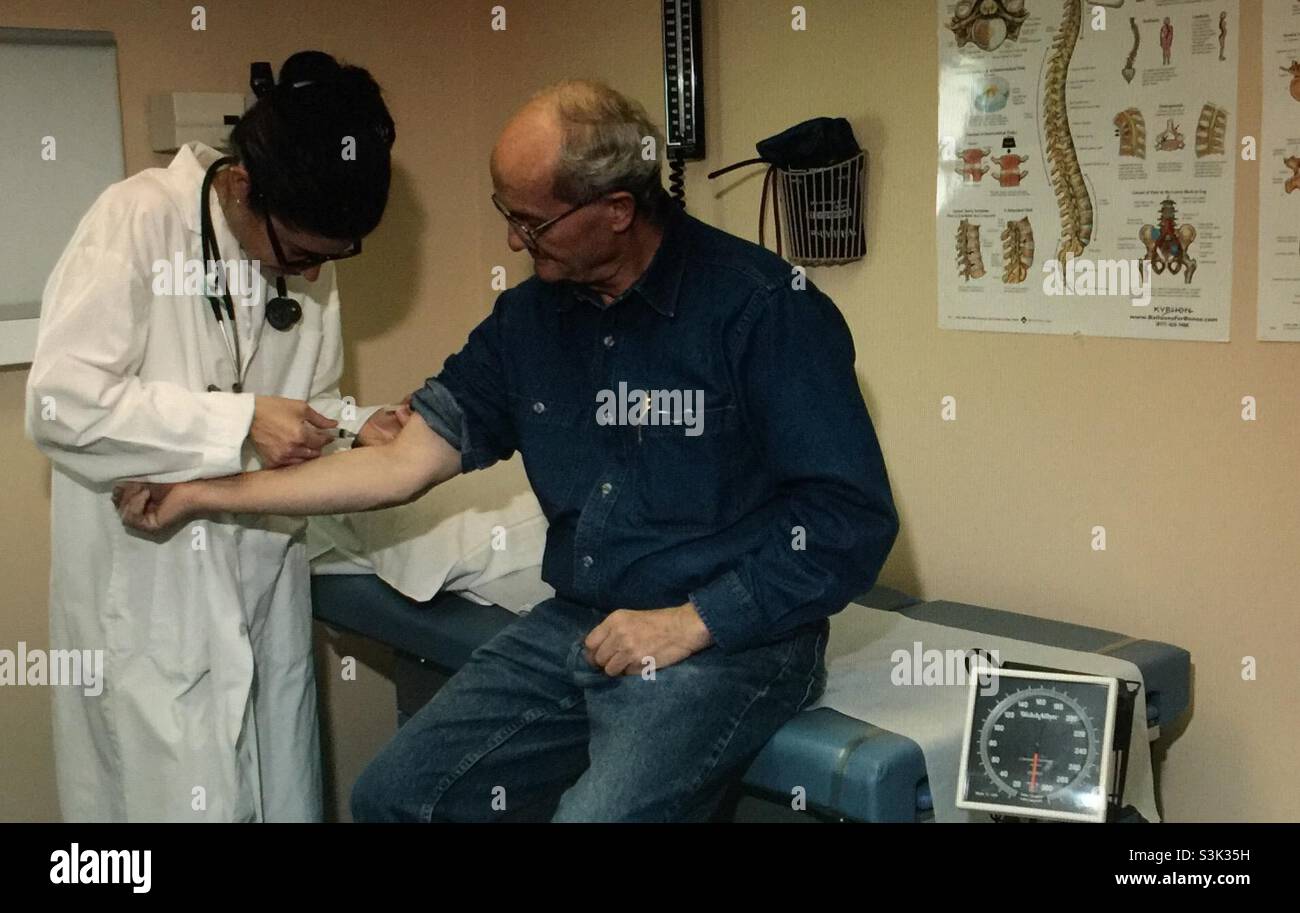 Doctor inserting the needle - Smartphone Captured Stock Image