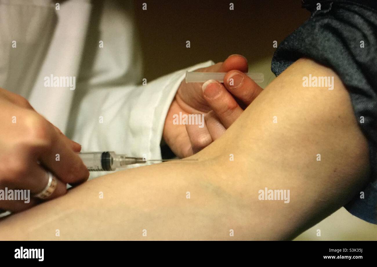 Doctor inserting the needle - Smartphone Captured Stock Image