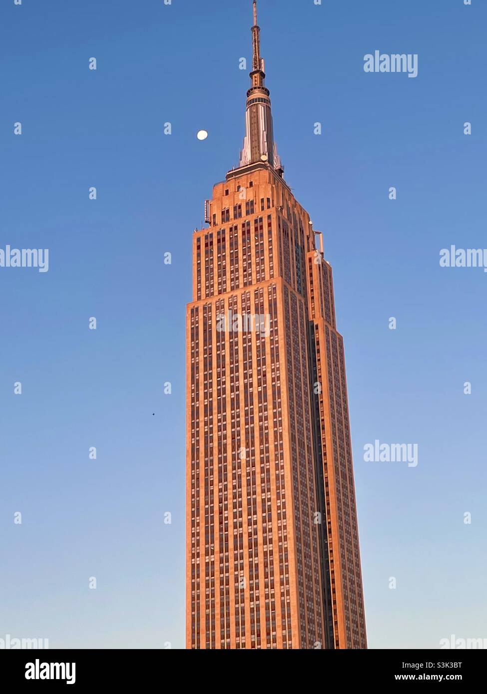 The moon approach is the Empire State building in the early morning - Smartphone Captured Stock Image