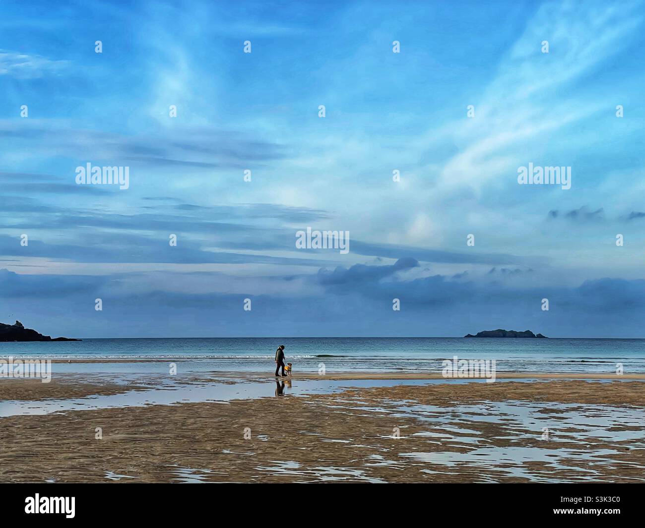 Dog walker on Harlyn Bay, North Cornwall coast, October. - Smartphone Captured Stock Image