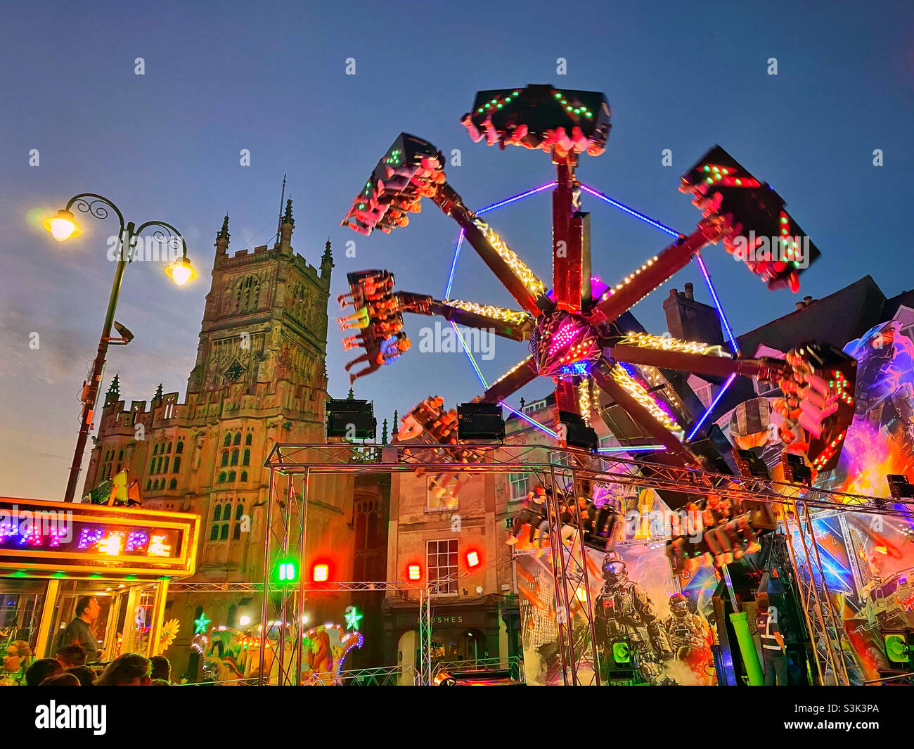 All the fun of an English fairground ride. It’s dusk, so the evening entertainment is about to start. Any fast rotating rides anybody?!! Photo ©️ COLIN HOSKINS. Stock Photo