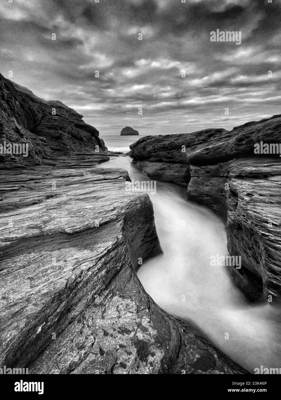 Trebarwith stream entering the sea on Trebarwith strand, North Cornwall, October. - Smartphone Captured Stock Image