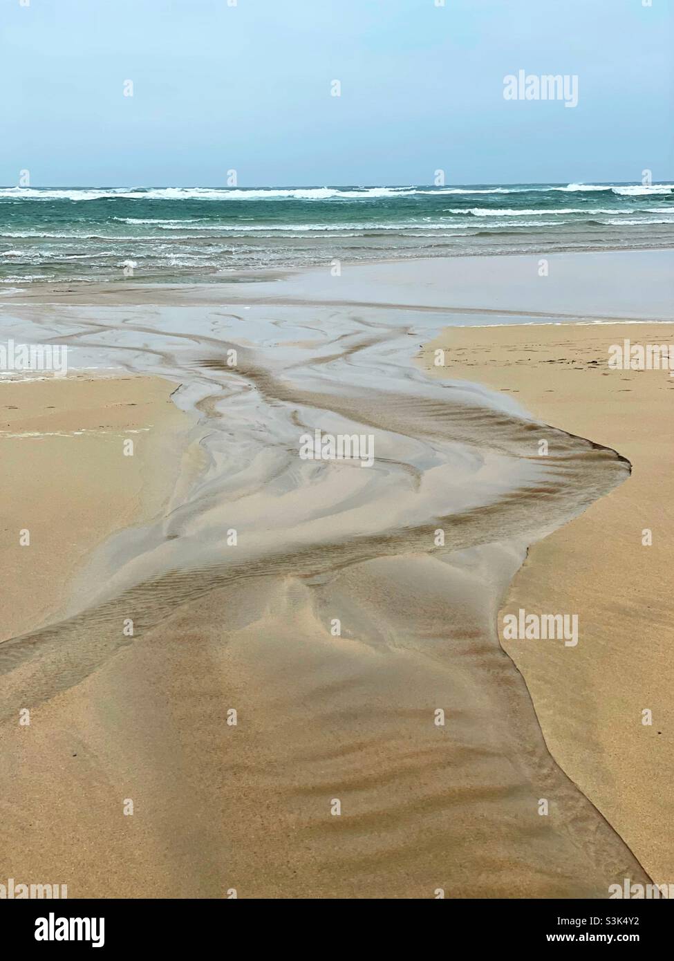 Stream meets the sea, Constantine bay, North Cornwall, October. - Smartphone Captured Stock Image