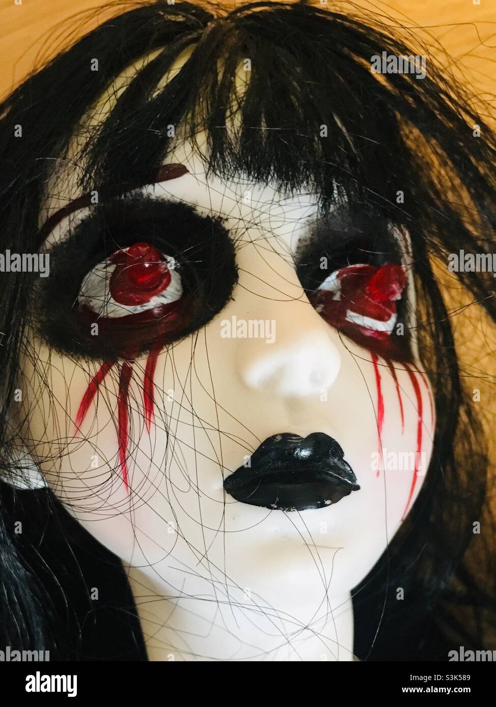 Close up of the scary black doll - Smartphone Captured Stock Image