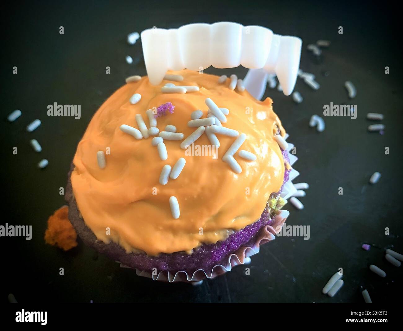 Halloween cupcakes with orange frosting and chocolate cake with sprinkles on top Stock Photo