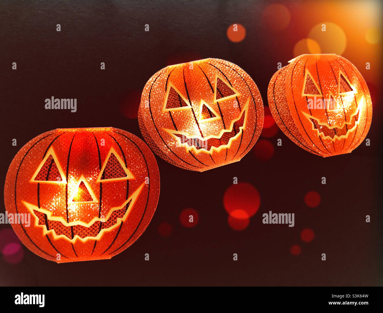 Spooky Halloween pumpkins lit up at night Stock Photo
