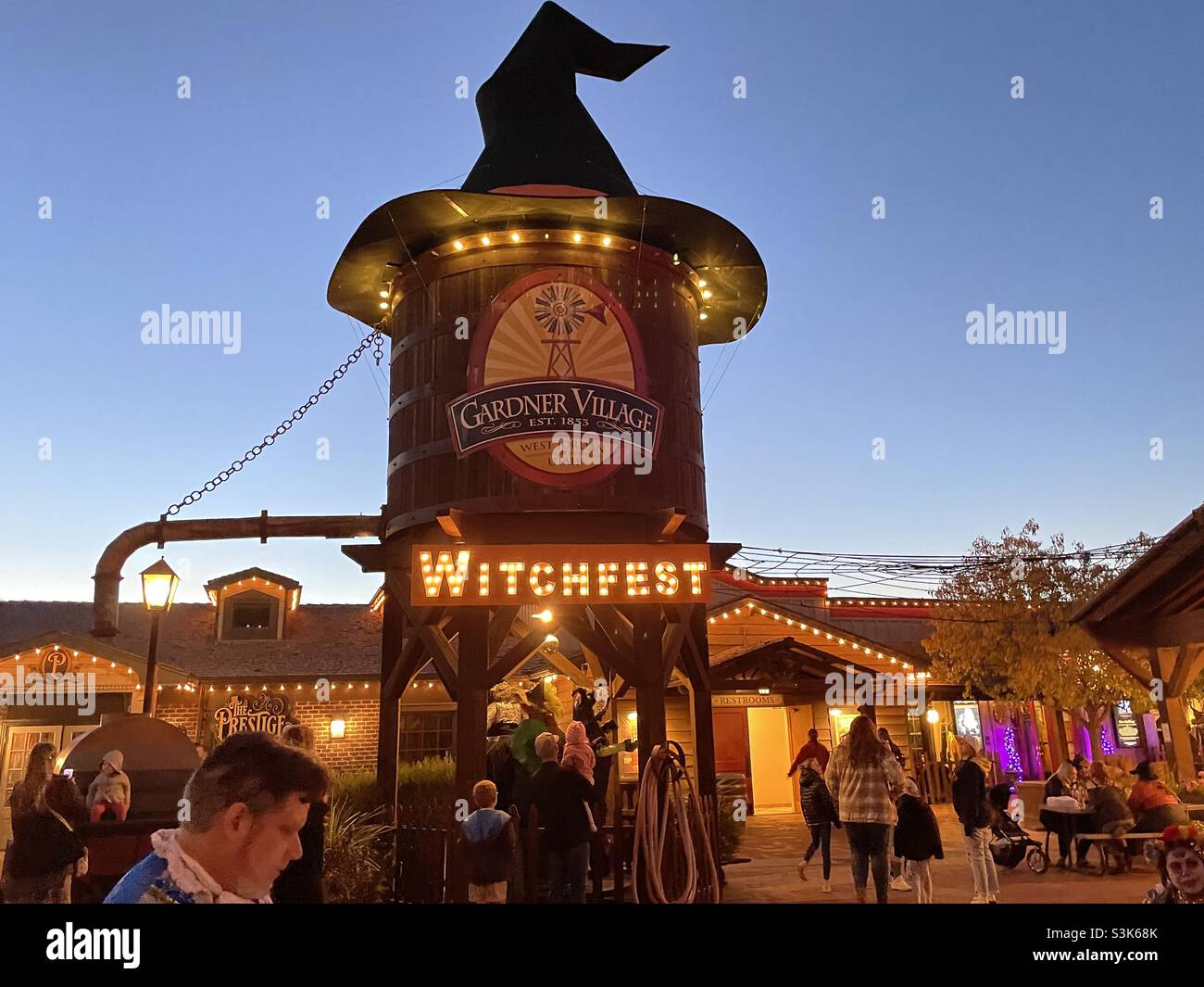 People milling and walking about midst the decorations at Gardner Village’s “WitchFest” in the Salt Lake valley of Utah, USA. Stock Photo