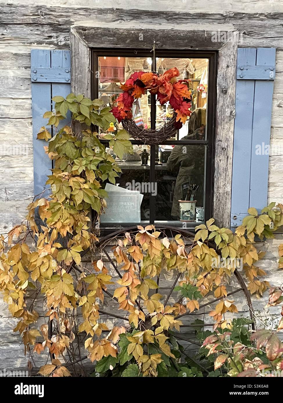 A rustic window at a local shop decorated for the fall festival at Gardner Village’s annual “WitchFest” in the Salt Lake valley of Utah, USA. Stock Photo